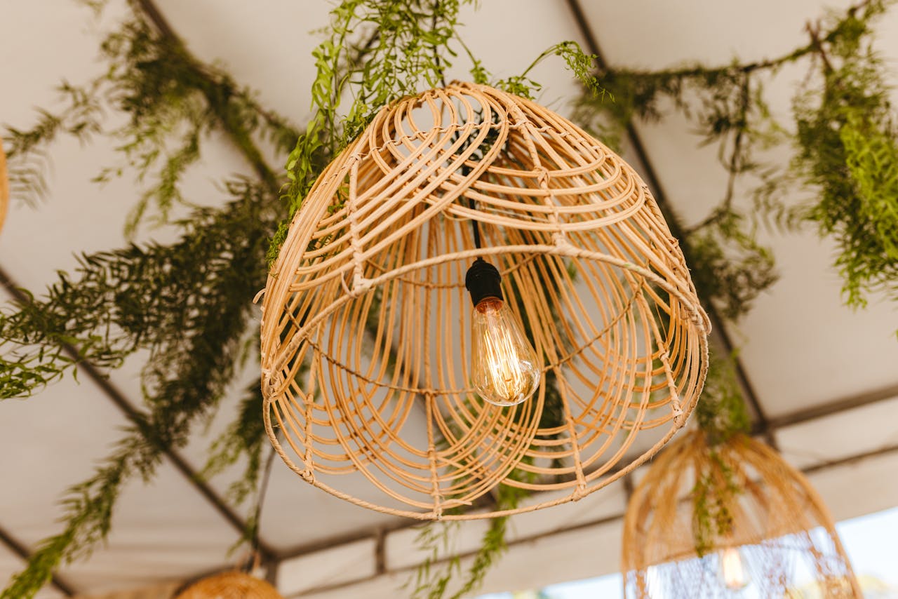 Close-up of a rustic bamboo chandelier with greenery, creating a bohemian atmosphere.